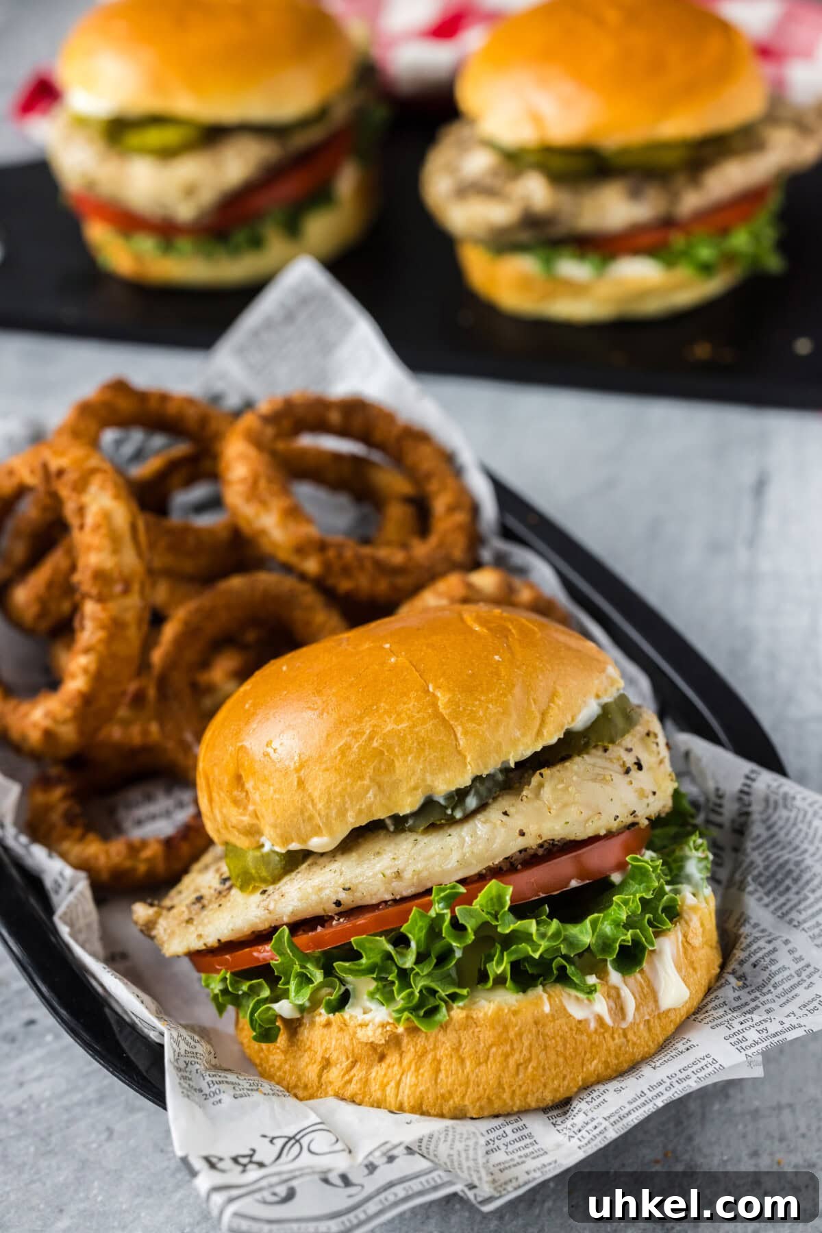 Crispy Chicken Sandwich Recipe with Tangy Slaw and Pickles 2 Chicken Sandwich in a basket with onion rings