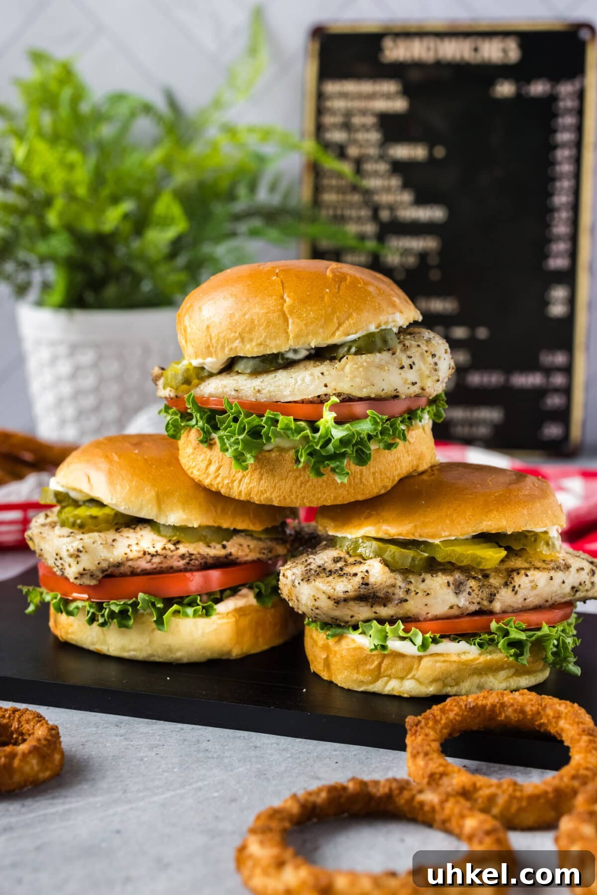 Crispy Chicken Sandwich Recipe with Tangy Slaw and Pickles 3 Three Chicken Sandwiches stacked on top of each other