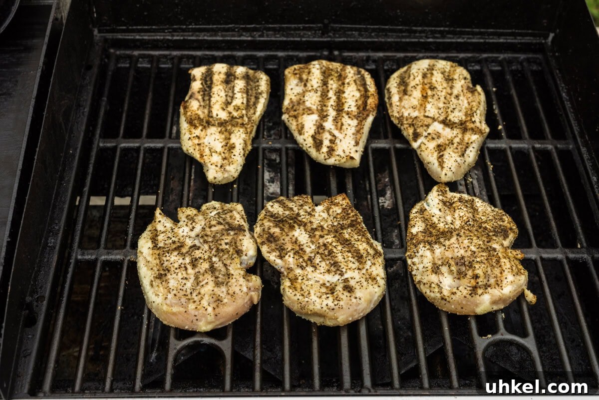 Crispy Chicken Sandwich Recipe with Tangy Slaw and Pickles 7 chicken breast with grill marks on a grill grate