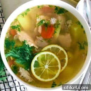 Authentic Ukha Fish Soup Recipe: Clear Russian Fisherman’s Broth 18 fish soup in white bowl next to spoon