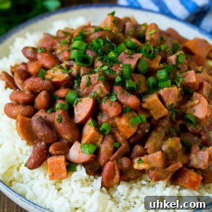 Red beans and rice with sausage, ham and vegetables, topped with herbs.