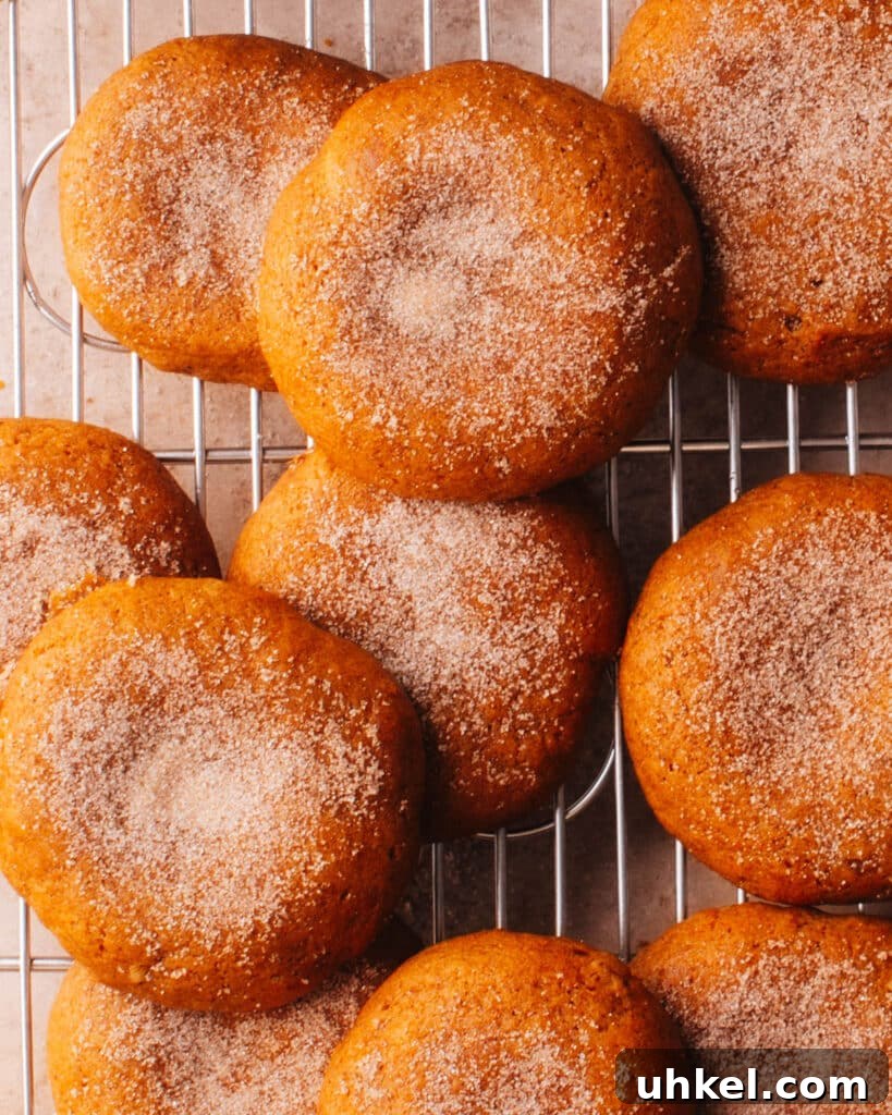 Soft pumpkin cookies on a cooling rack.