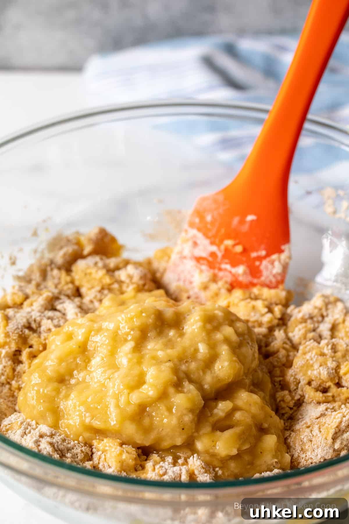 Moist Banana Walnut Muffins with Cinnamon Streusel 6 Adding mashed bananas to muffin batter.