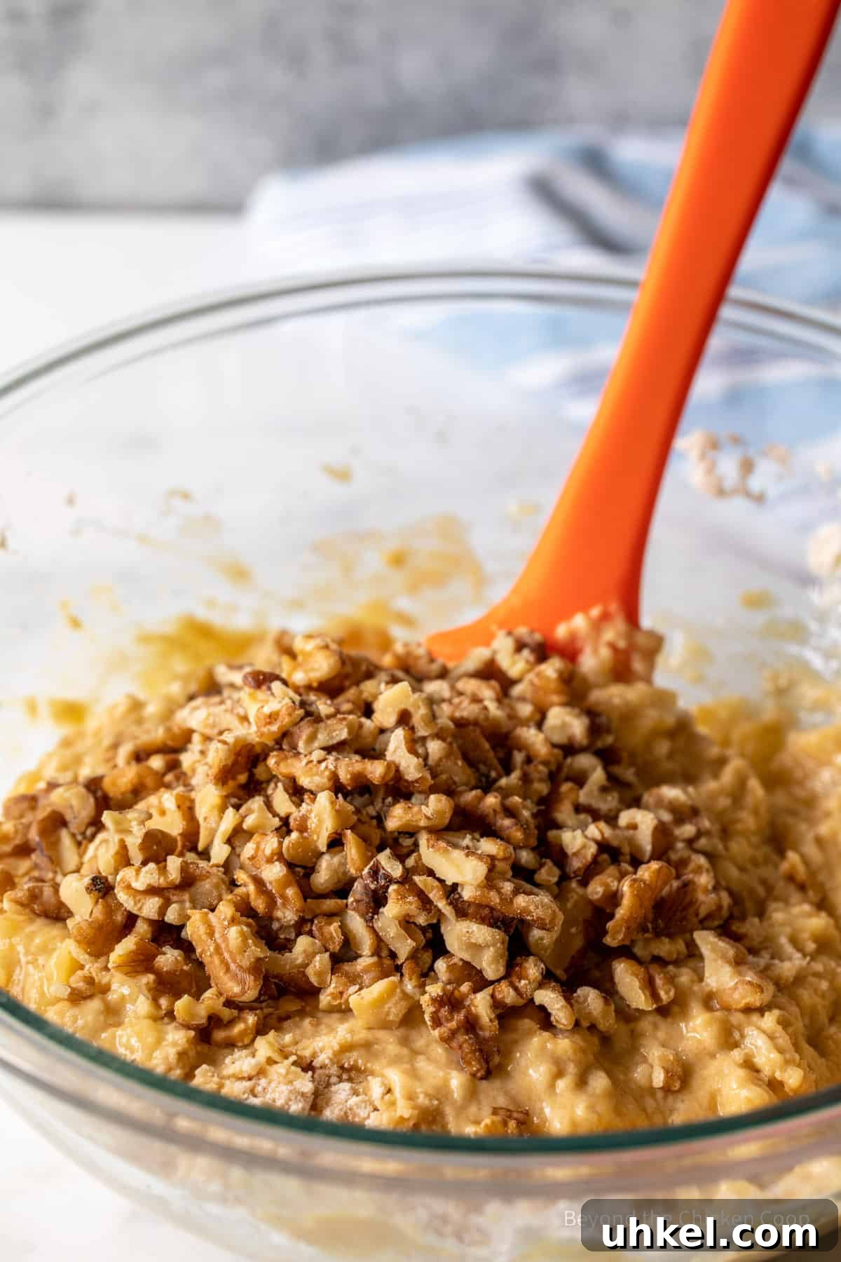 Moist Banana Walnut Muffins with Cinnamon Streusel 7 Stirring walnuts into muffin batter.