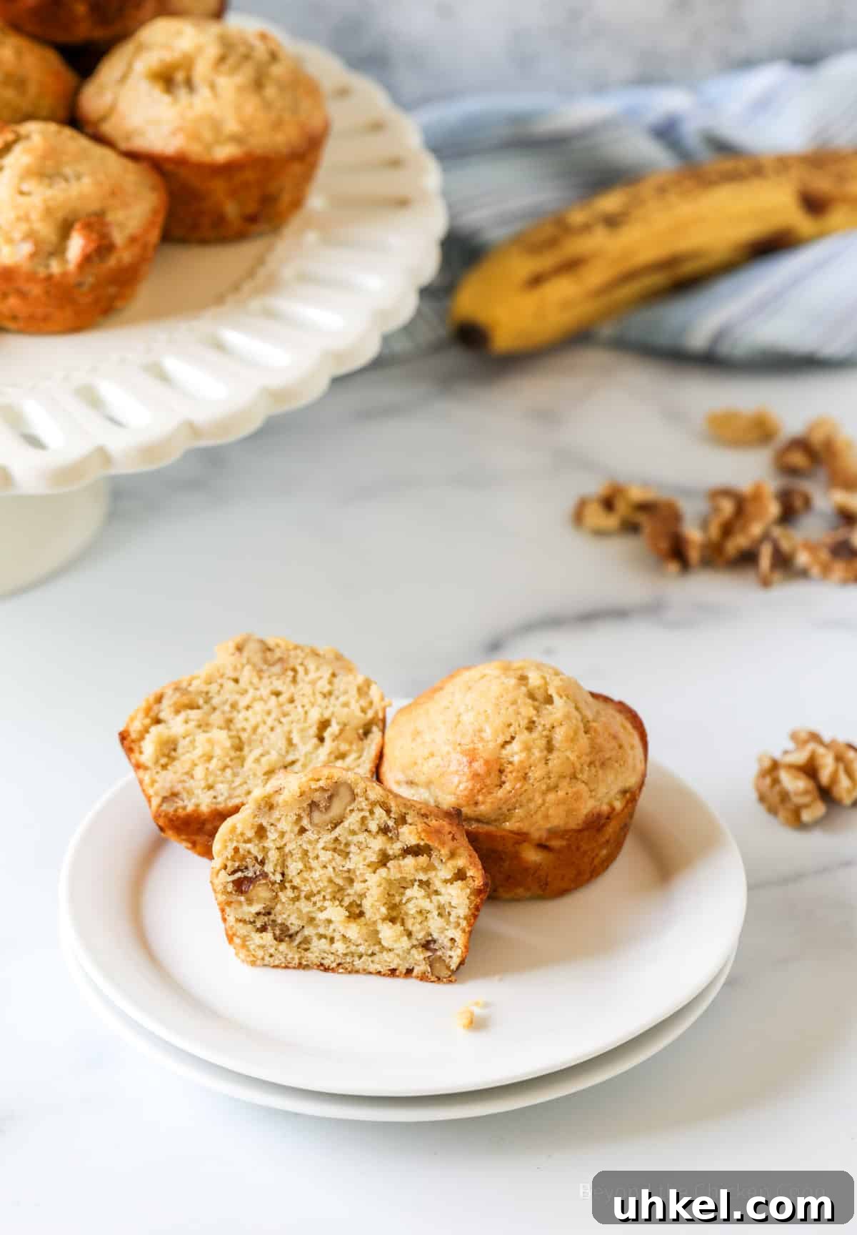 Moist Banana Walnut Muffins with Cinnamon Streusel 8 A muffin cut in half on a plate.
