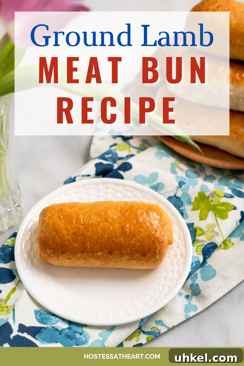 Ground Lamb Stuffed Buns Recipe – Savory Meat-Filled Bread 12 Top-down view of a baked bun filled with ground lamb and cheese. A plate of more meat buns sit in the background.