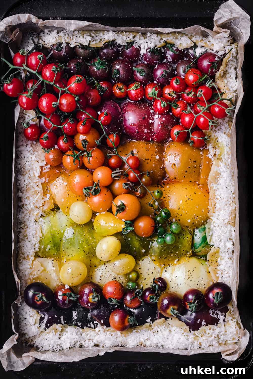 Ultimate Tomato Galette Recipe You’ll Make Again and Again 5 pre-oven tomato galette in a pan with parchment paper ready to be baked