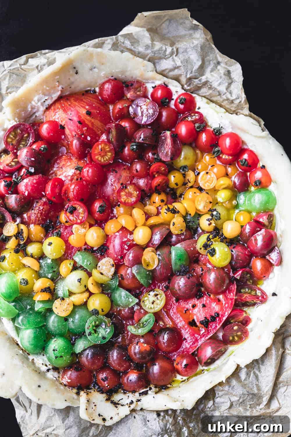 Ultimate Tomato Galette Recipe You’ll Make Again and Again 8 a raw tomato galette topped with chili flakes and other seasoning