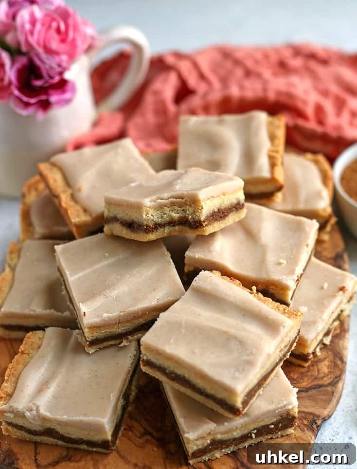 Paleo Vegan Brown Sugar Pop-Tart Bars Recipe 6 brown sugar pop tart bars stacked on a wooden cutting board
