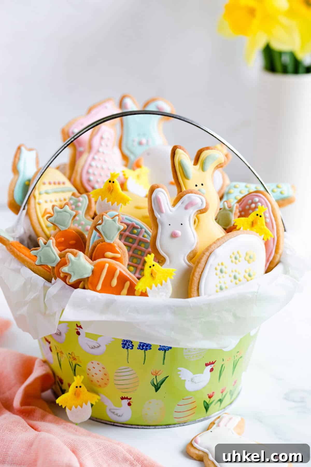 Easter Sugar Cookie Recipe with Simple Decorating Ideas 2 side close up of basket filled with Easter sugar cookies with coloured icing