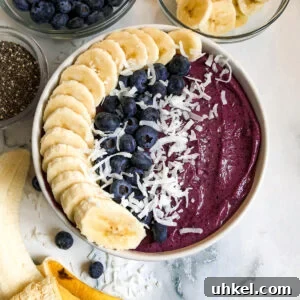 Blueberry Smoothie Bowl Recipe for Creamy, Antioxidant-Rich Mornings 4 blueberry smoothie bowl with sliced bananas, fresh blueberries, and chia seeds.