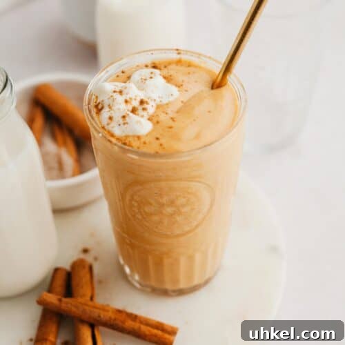 A pumpkin smoothie in a large glass.