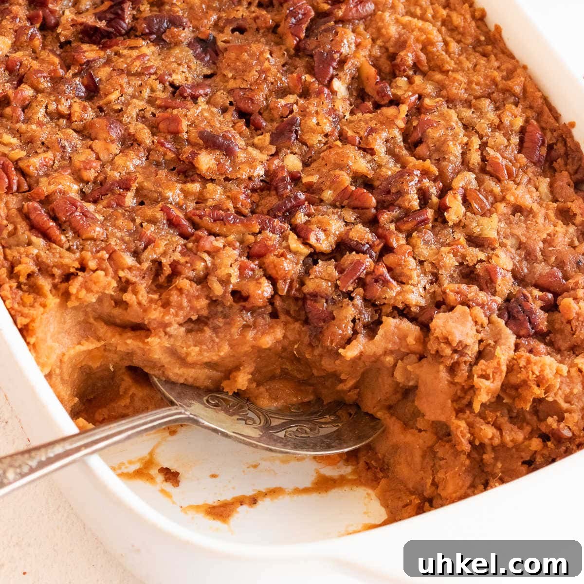 15 Perfect Side Dishes to Serve with Ham This Holiday 11 Close up of sweet potato crunch casserole with a serving removed from dish.