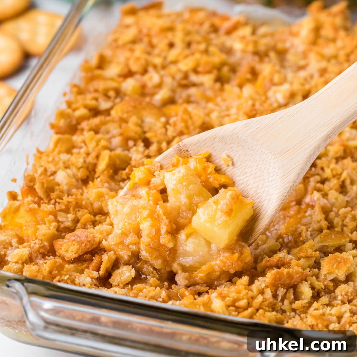 15 Perfect Side Dishes to Serve with Ham This Holiday 5 A crunchy topped casserole with a serving spoon in it.