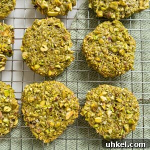 Authentic Italian Pistachio Cookies Recipe for Crispy, Nutty Treats 14 Italian pistachio cookies on a cooling rack.