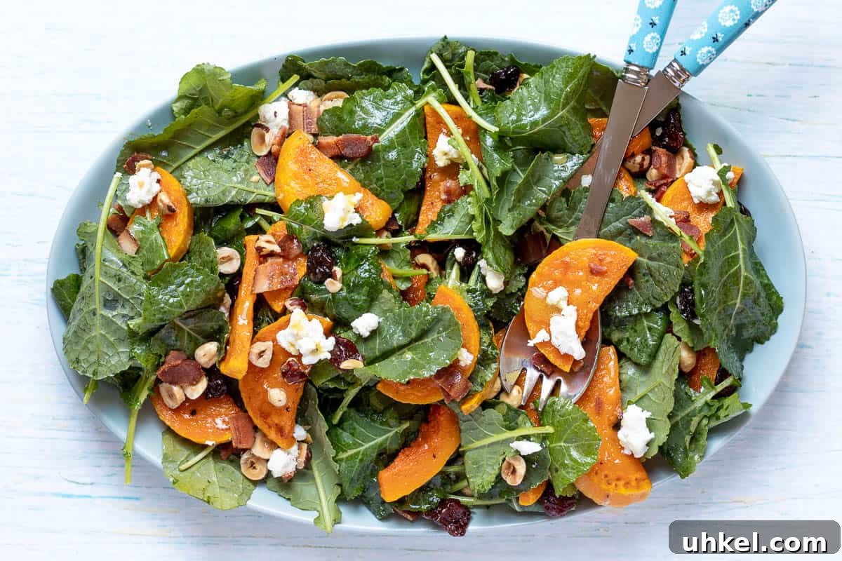 19 Fall Harvest Salads to Brighten Your Table This Season 2 kale butternut squash salad on large platter with tongs.