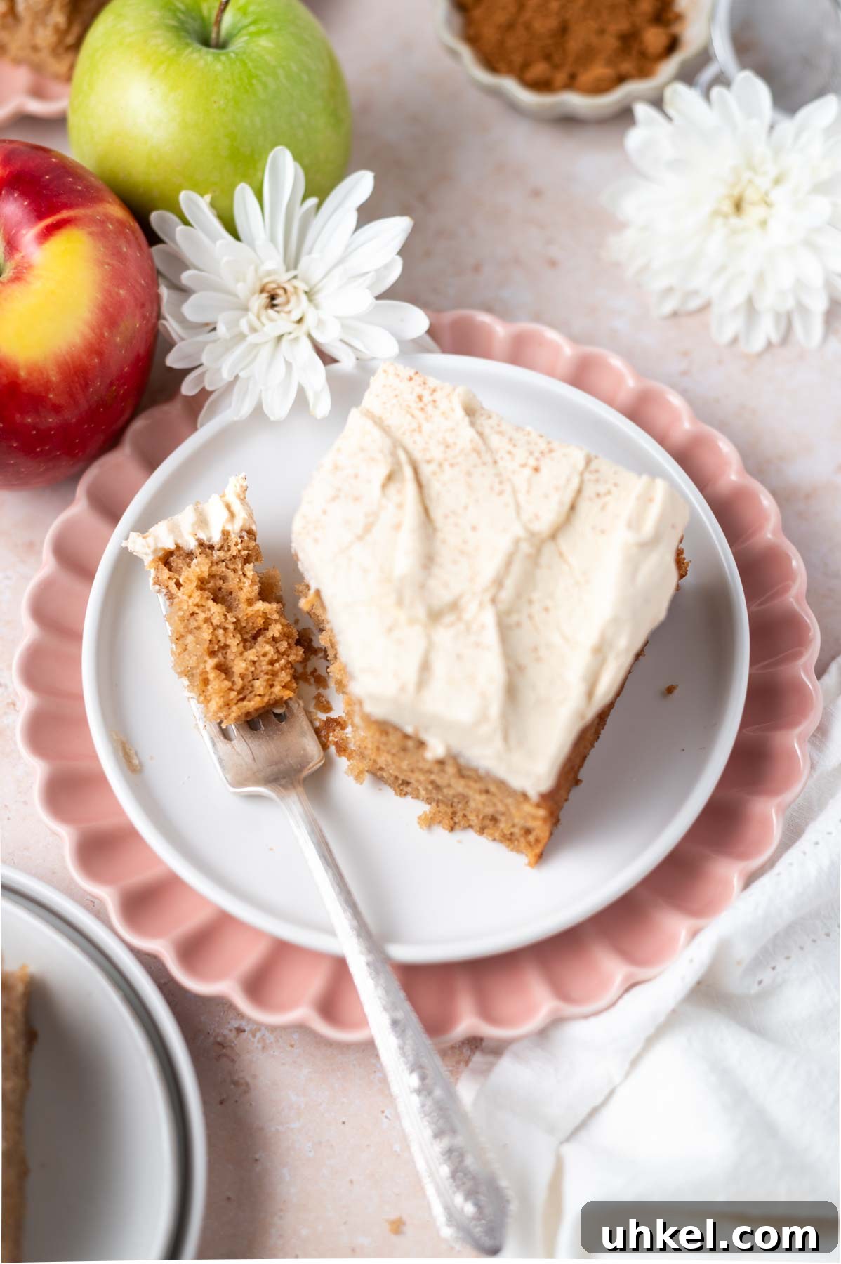 Apple Cider Snack Cake with Tender Apples 11 slice of cake on a plate with a bite on a fork