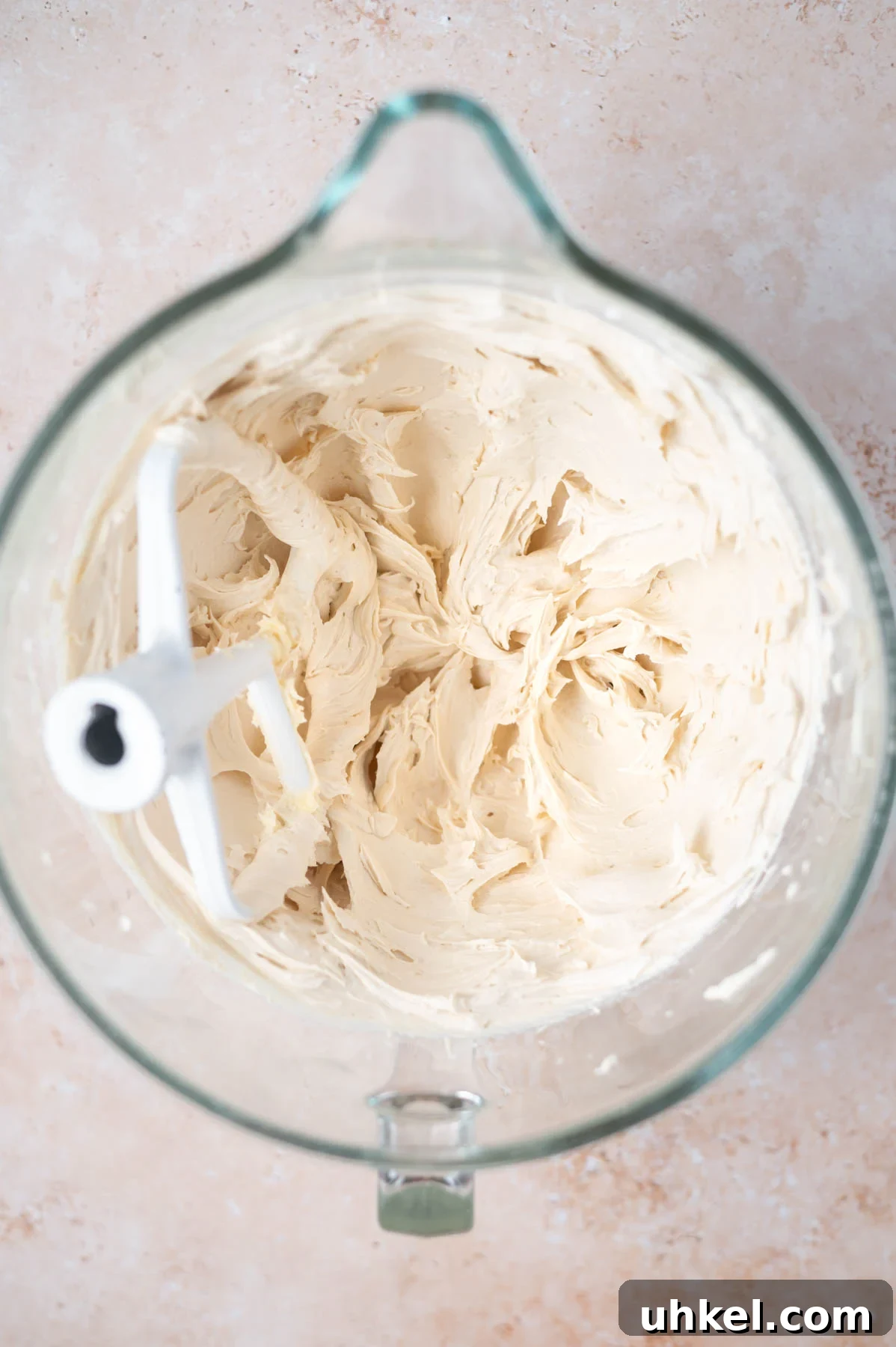 Apple Cider Snack Cake with Tender Apples 9 frosting in a mixing bowl
