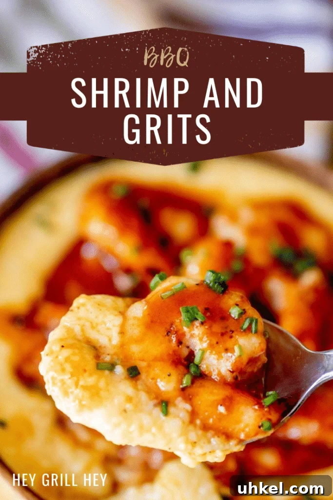 Grilled BBQ Shrimp with Creamy Southern Grits 2 Close up image of cheesy grits and BBQ sauce covered shrimp on a silver spoon. Text overlay reads: BBQ Shrimp and Grits.