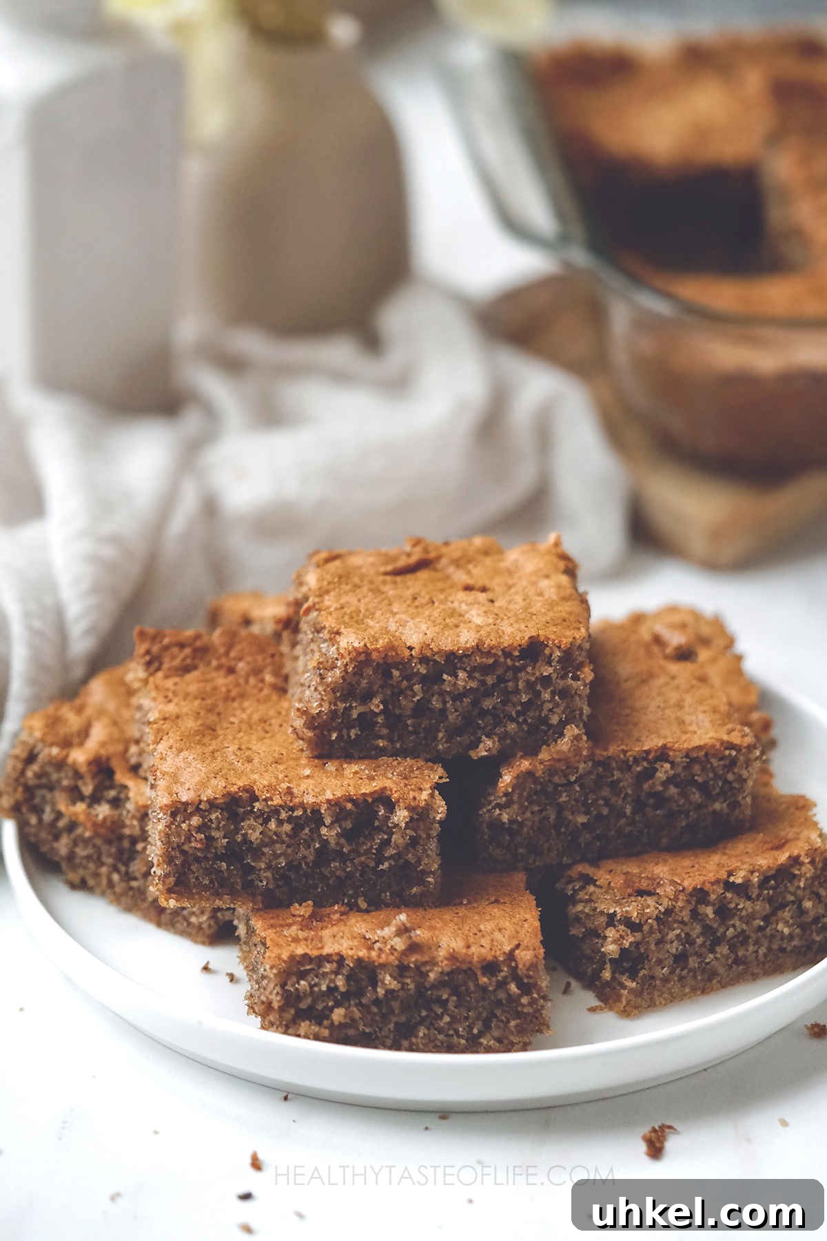 Greek-Inspired Walnut Cake with Gluten-Free Option 3 Walnut coffee cake similar to karidopita cut into squares, stacked on a plate.
