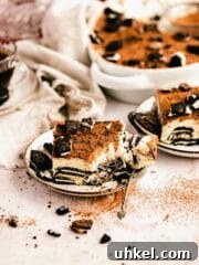taking a bite of oreo tiramisu on plate
