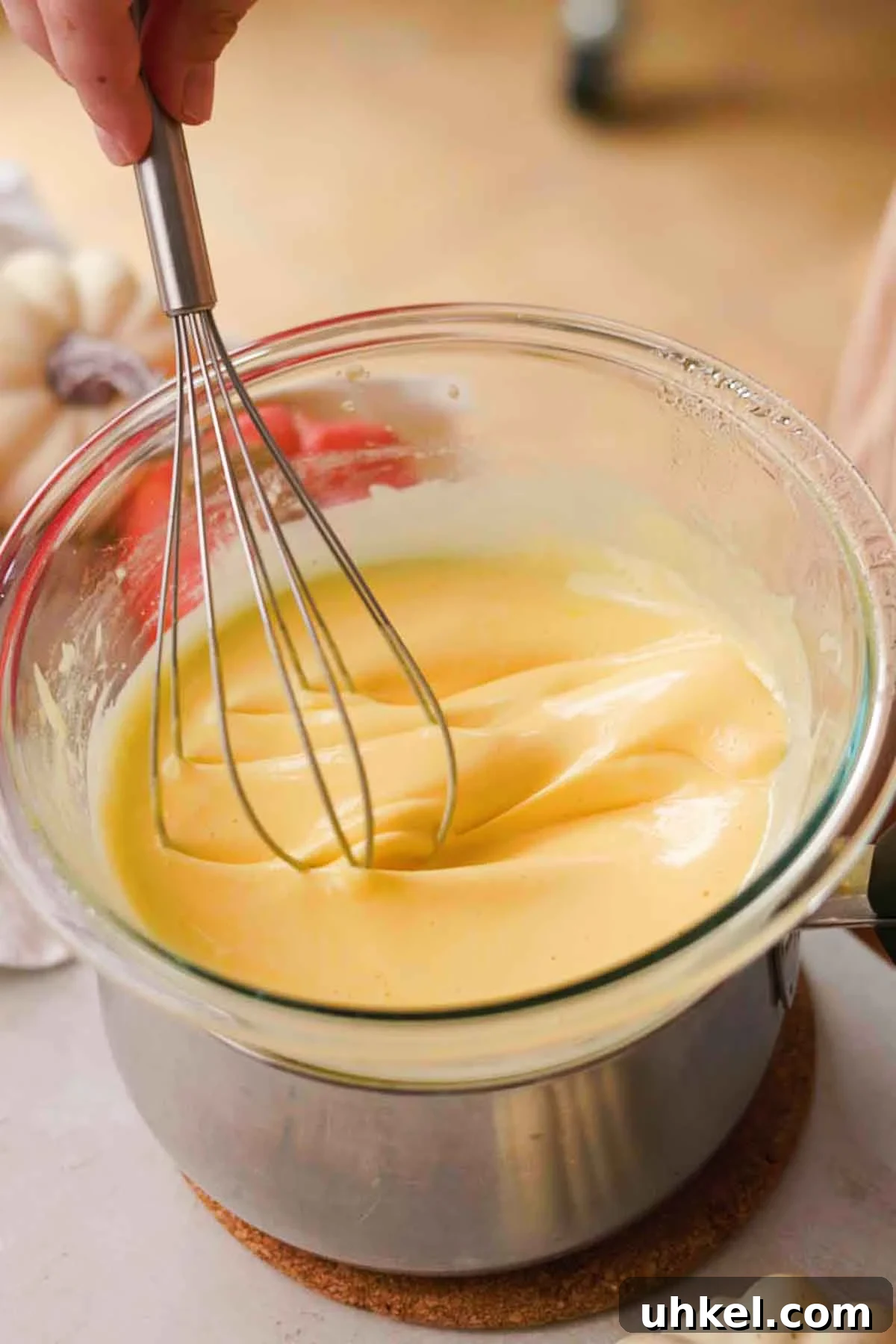 Pumpkin Tiramisu Recipe: Creamy Autumn Dessert with Mascarpone 6 whisking egg mixture on saucepan