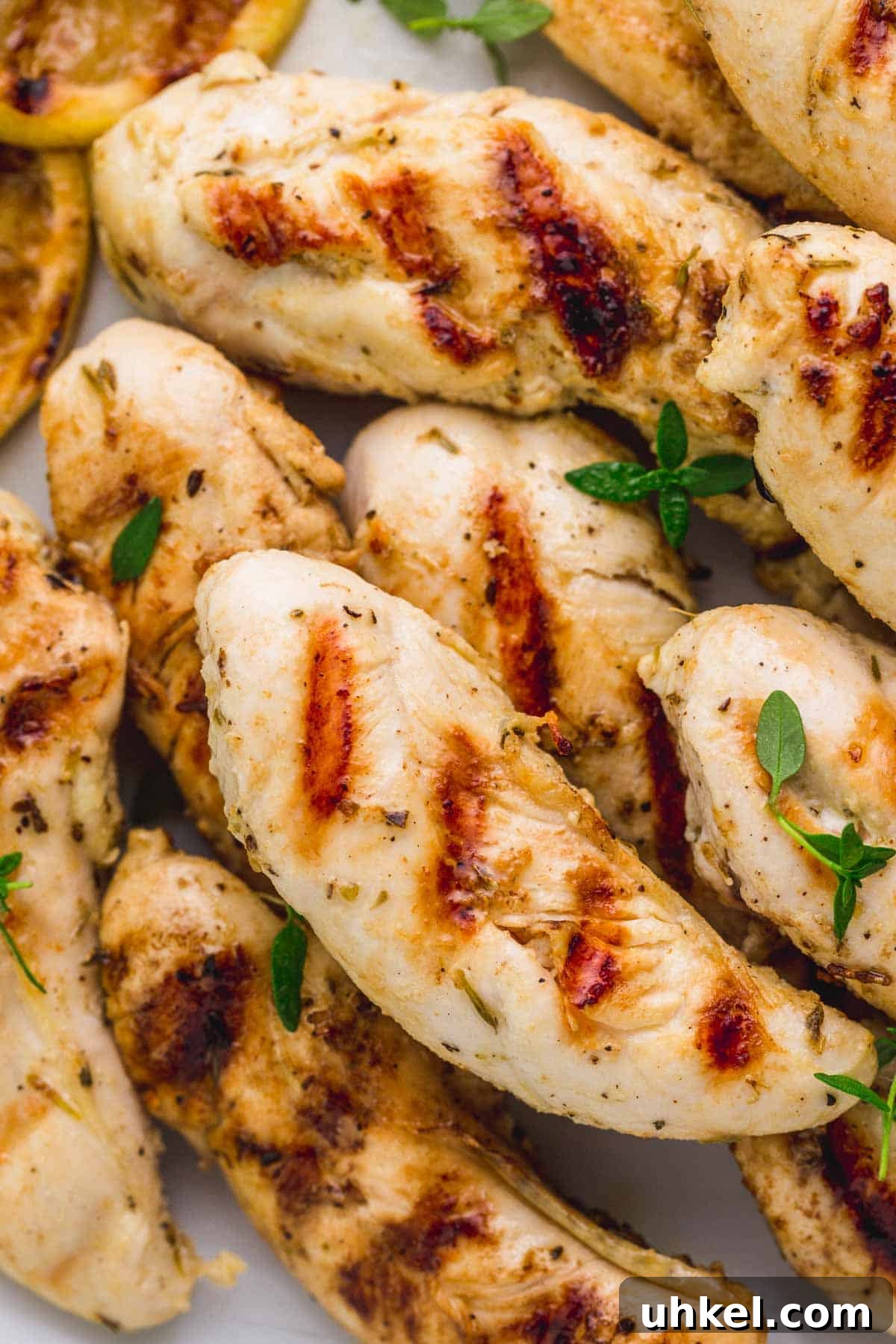 Crispy Grilled Chicken Tenders with Tangy BBQ Glaze 5 Close up of grilled chicken tenders and fresh thyme leaves