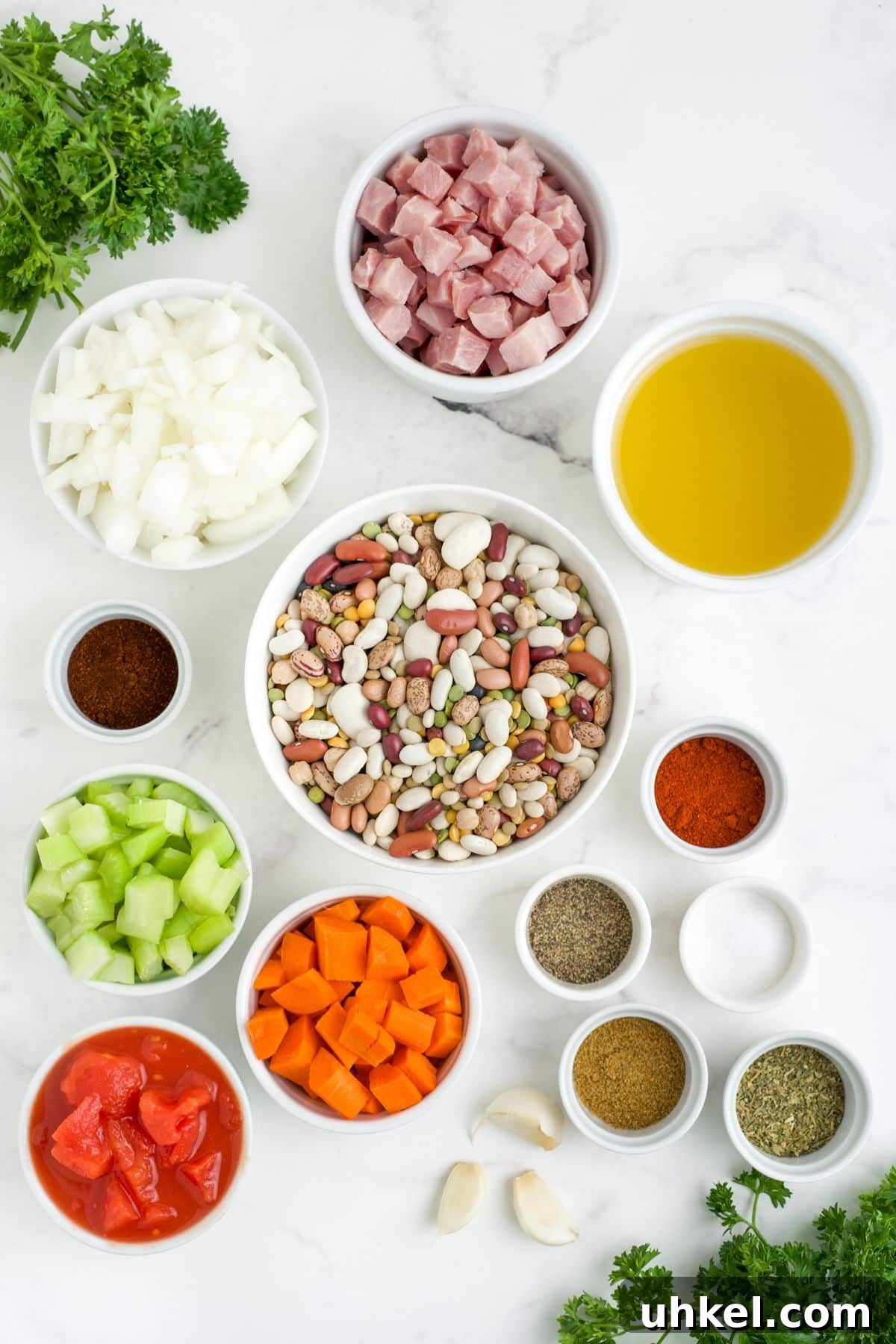 Hearty Slow Cooker 15-Bean Soup Recipe for Meal Prep 3 Ingredients to make crock pot 15 bean soup on the table in white bowls before mixing.