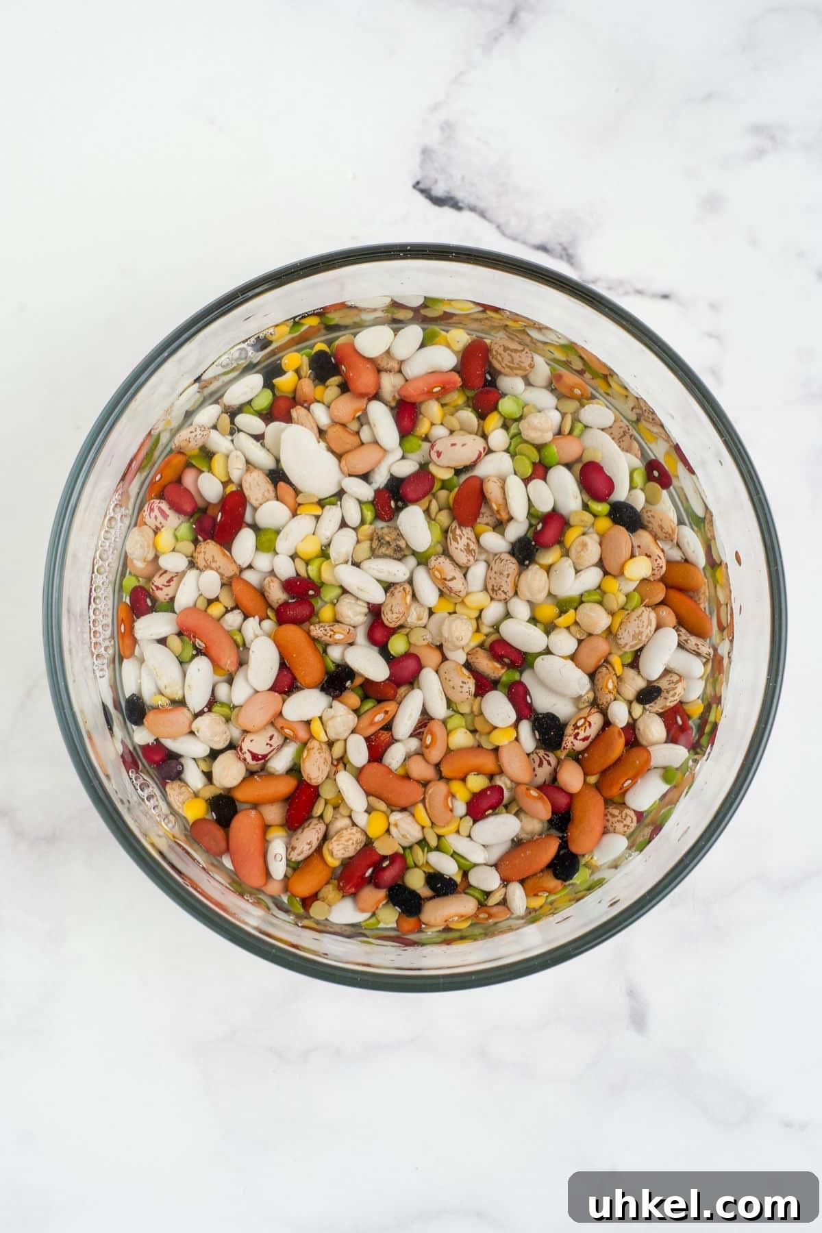 Hearty Slow Cooker 15-Bean Soup Recipe for Meal Prep 4 Bean mixture soaking in water.