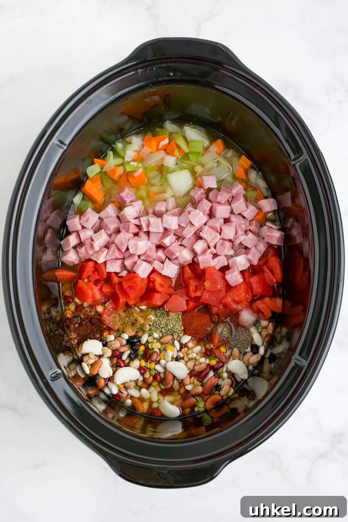 Hearty Slow Cooker 15-Bean Soup Recipe for Meal Prep 6 Ingredients added to the crock pot to make bean soup.