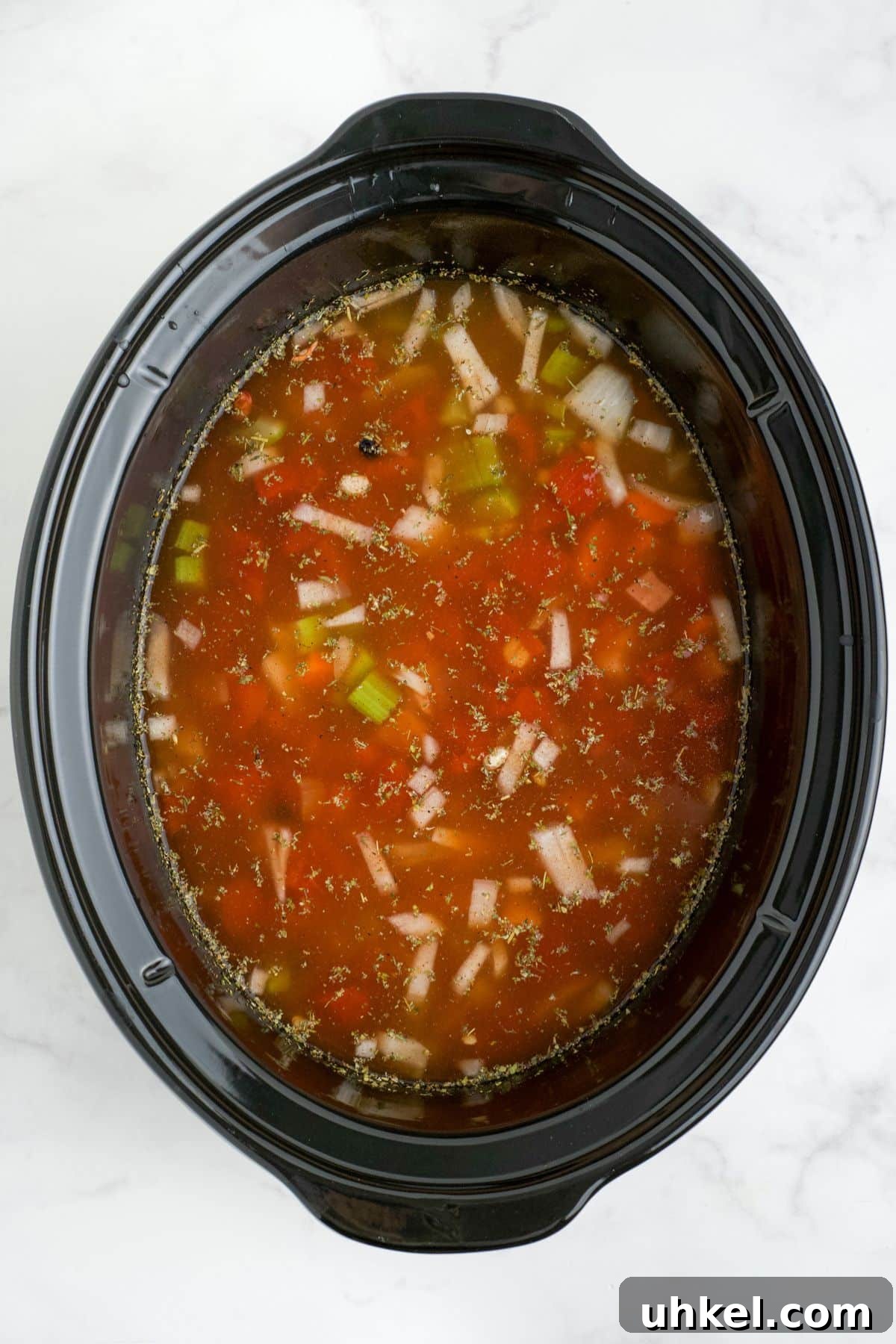 Hearty Slow Cooker 15-Bean Soup Recipe for Meal Prep 7 Broth added to the pot to cook.