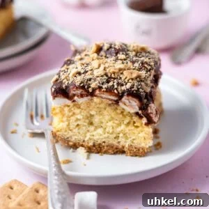 slice of s'mores cake on a plate with a fork