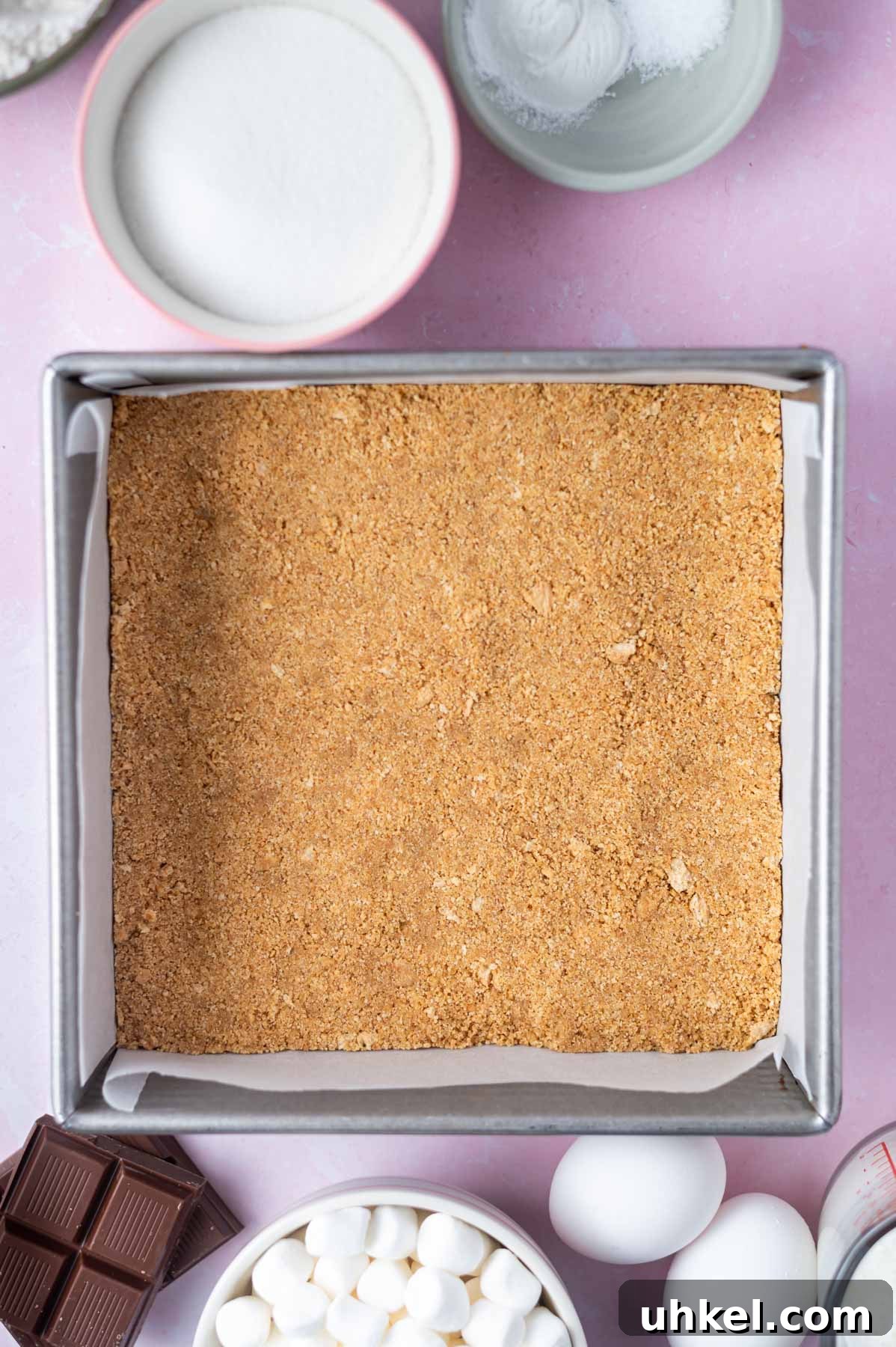 graham cracker crust pressed into a parchment lined 8x8 pan