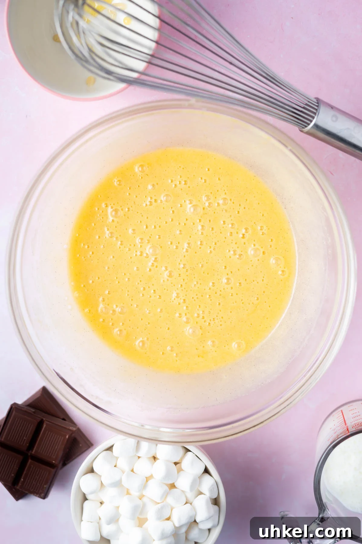 eggs whisked into batter in a bowl