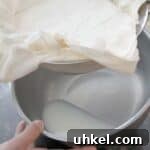 How to Strain Ricotta for Creamier, Thicker Cheese 2 liquid in bowl after draining ricotta cheese