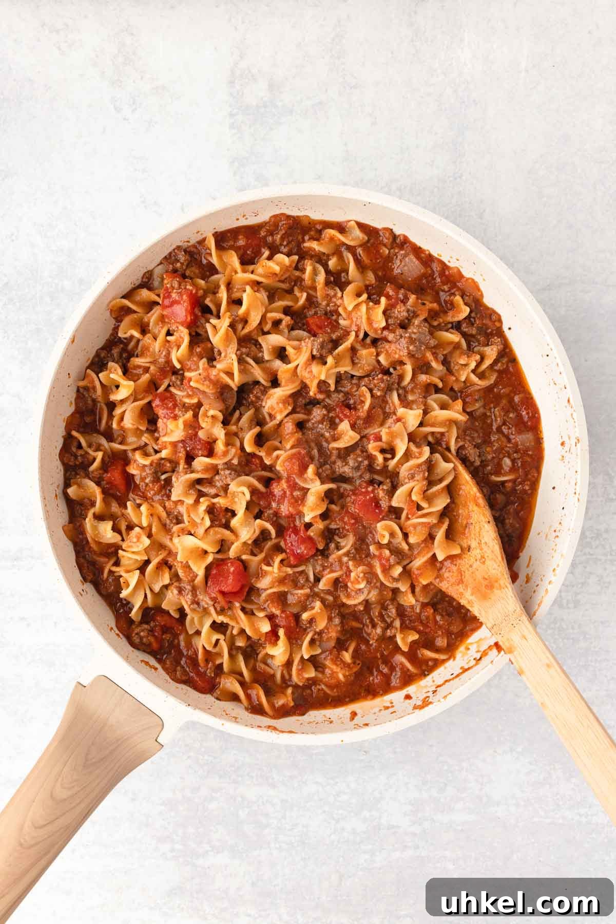 Italian Beef and Egg Noodle Casserole with Tomatoes and Cheese 6 The noodles are added back to the skillet and combined with the sauce.