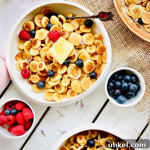 Mini Pancake Cereal Recipe: Bite-Sized Pancakes for Breakfast 8 mini pancakes with blueberries and raspberries
