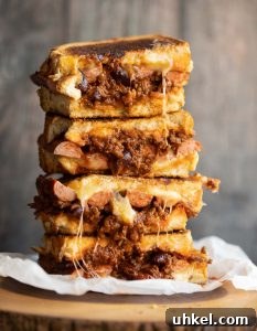 Chili Cheese Dog Grilled Cheese 4 sandwich halves stacked with chili spilling out