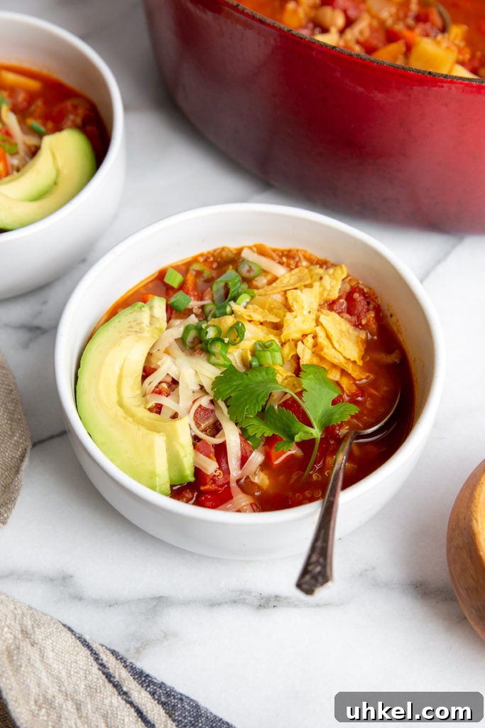 Hearty Vegan Quinoa Chili Recipe: Protein-Packed & Flavorful 13 Close up of the chili in a bowl with the pot in the background.