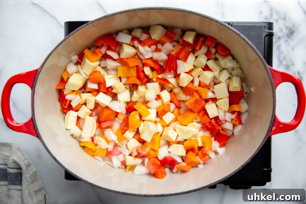 Hearty Vegan Quinoa Chili Recipe: Protein-Packed & Flavorful 6 Process shot showing the vegetables cooking in a pot for the vegan chili.
