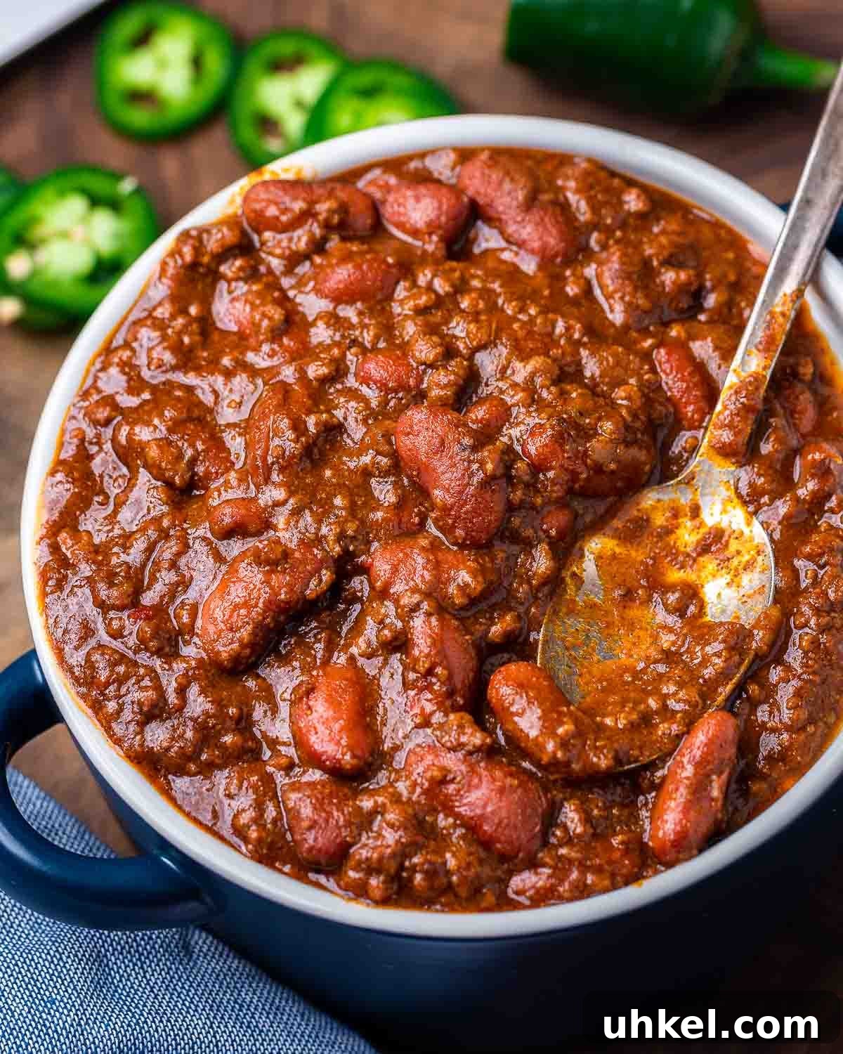 Authentic Classic Chili Recipe for Hearty Weeknight Dinners 2 Large bowl of chili with jalapenos in the background.