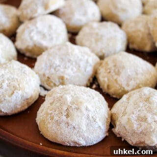 Gluten-Free Mexican Wedding Cookies — Simple, Delicious Recipe 4 mexican wedding cookies on a platter.
