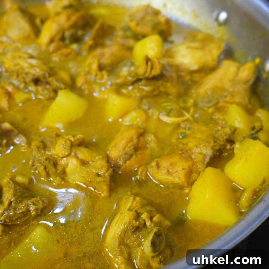 Authentic Jamaican Curry Chicken Recipe: Rich Island Flavor 9 Close up of finished Jamaican curry chicken in a pan.