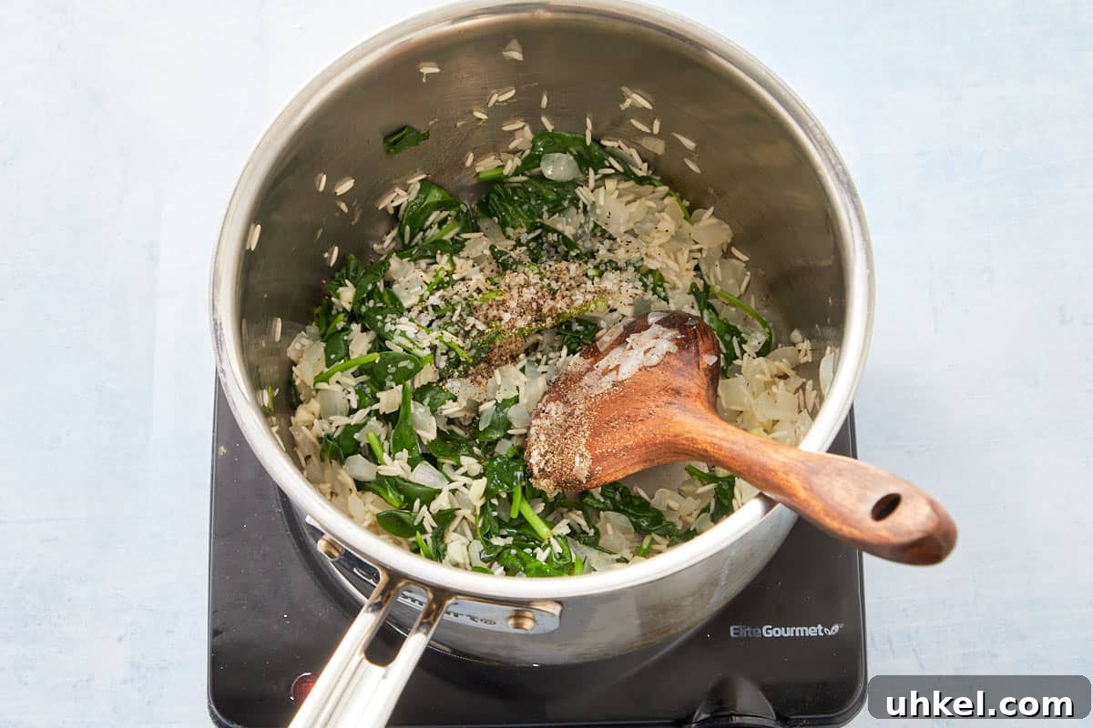 Mixing parsley and lemon juice into the cooked spinach and rice mixture.