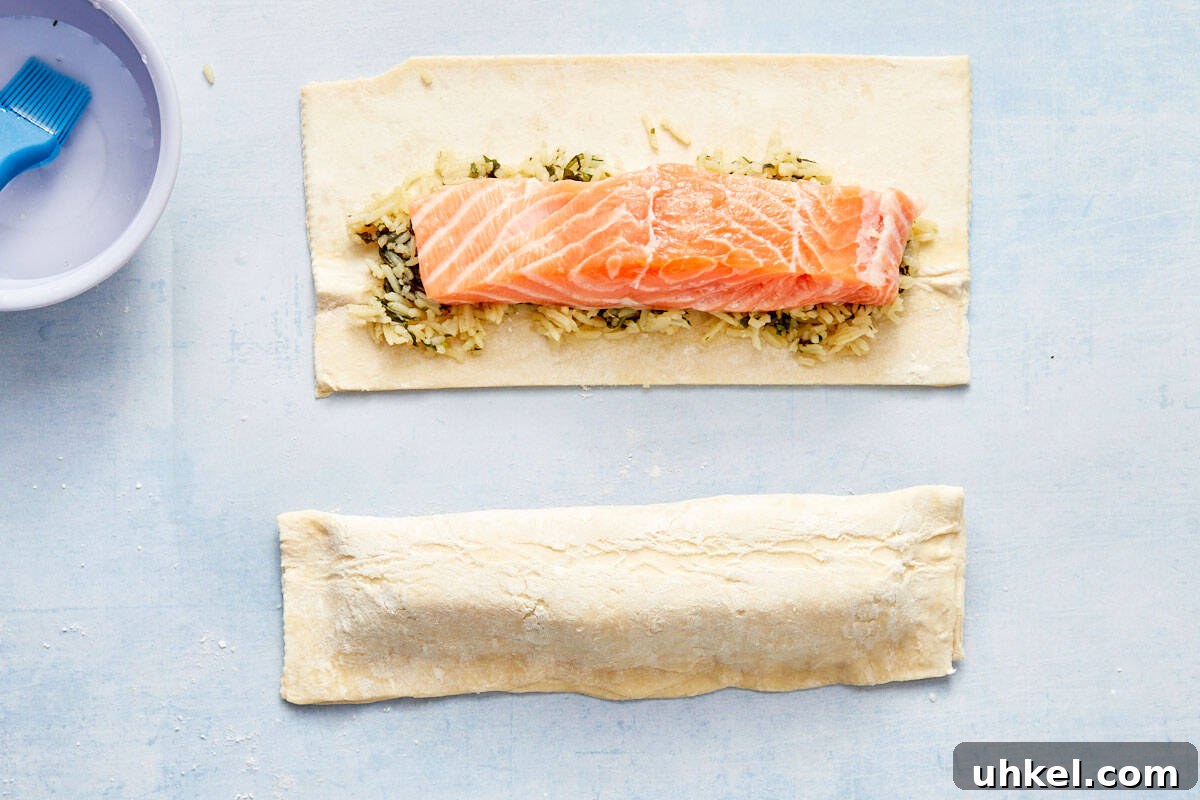 Salmon fillet placed over the spinach and rice mixture on pastry.
