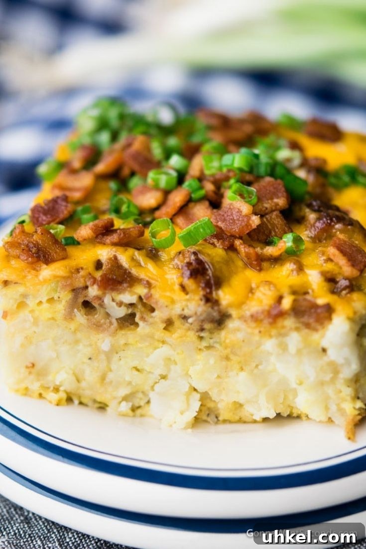 Tater Tot Breakfast Casserole is an easy cheesy blend of the best breakfast items to create tasty layers that satisfy a hungry crowd. A slice of Tater Tot Breakfast Casserole on a plate