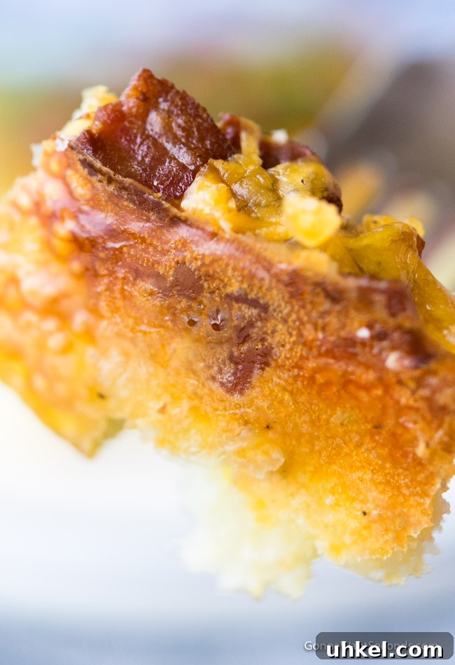 Cheesy Tater Tot Breakfast Casserole with Sausage and Veggies 2 Close up, easy tater tot breakfast casserole on a fork