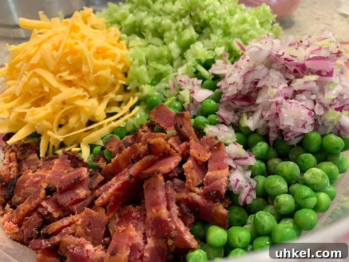 Creamy English Pea Salad with Bacon and Mint 4 Pea salad ingredients: bacon, cheese, celery, bacon and red onions.