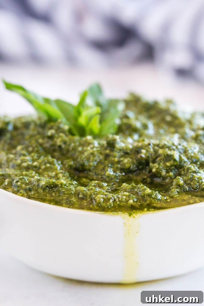 Classic Basil Pesto Recipe: Fresh, Vibrant Sauce for Pasta & More 12 A white bowl overflowing with freshly made basil pesto.