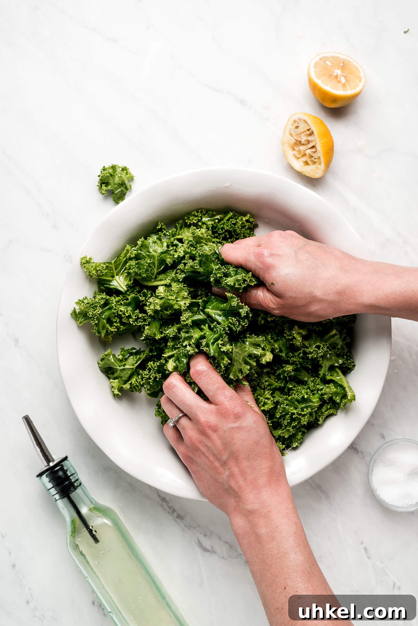 How to Massage Kale for Tender, Flavorful Salads 4 Photo showing how to massage kale by grabbing it in hands and rubbing it between fingers.